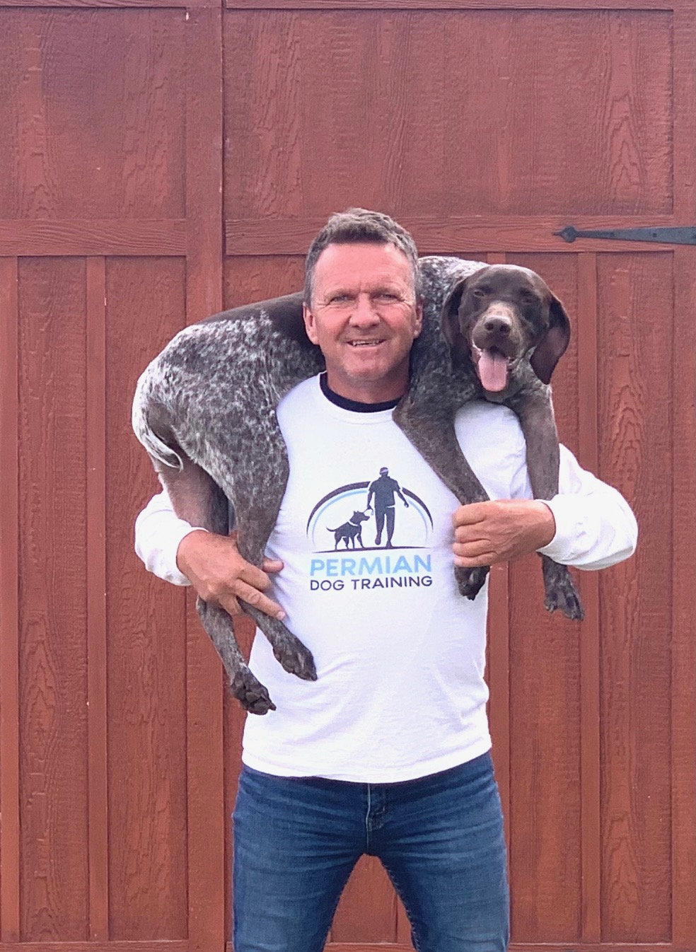 Trainer carrying a dog